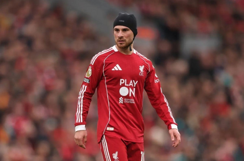 Why does Mac Allister have to wear a protective helmet in the big match against MU?