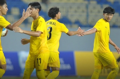 Malaysian fans collectively chant Vietnam's name following a decisive victory over Laos