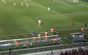 Indonesian U19 player pushes over Vietnamese U19 assistant coach while celebrating a goal.