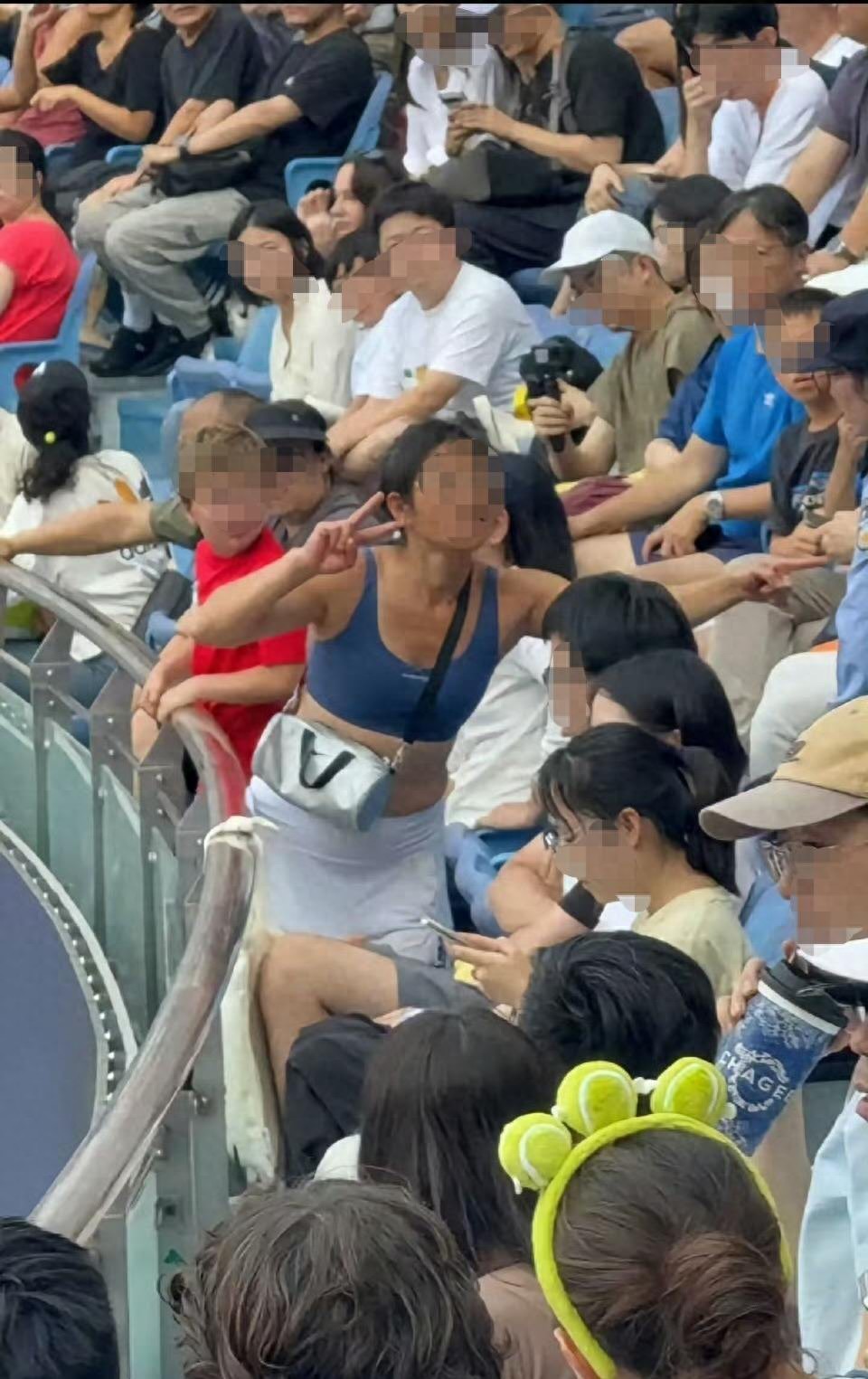 A woman at the Shanghai Masters women's event flaunted her passport and screamed, disrupting the match, and was forcibly removed to applause from the audience.