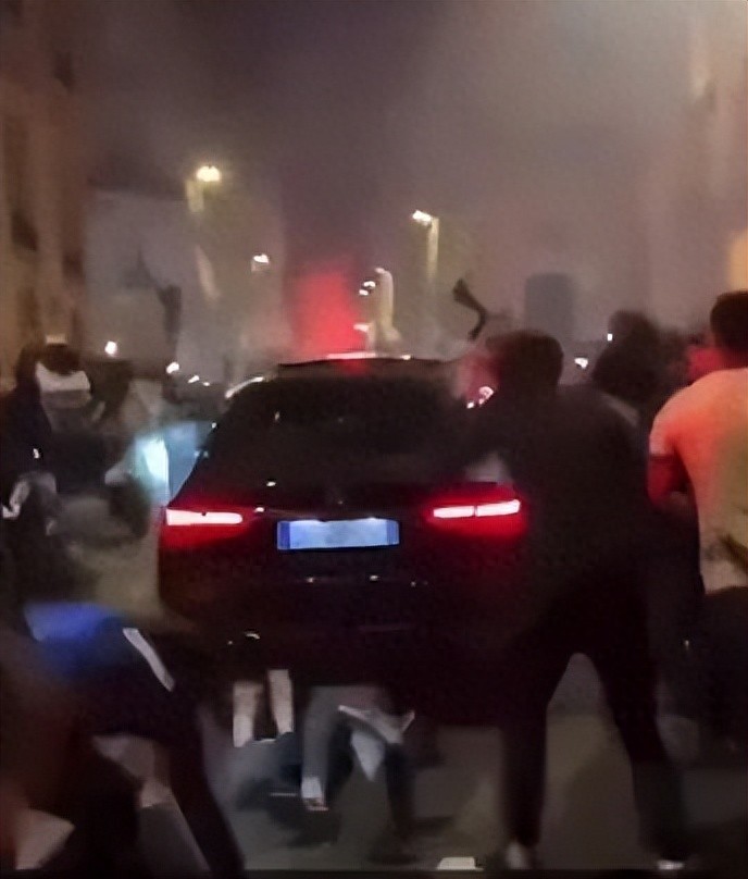 Fans celebrate Grand Paris' qualification to the Champions League final on the Champs-Élysées when a car crashes into the crowd