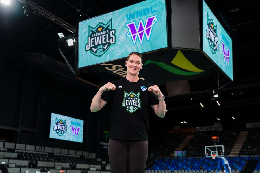 Kayla Steindl, Assistant General Manager of the Tasmania Jewels, reveals the club logo on Monday. 
