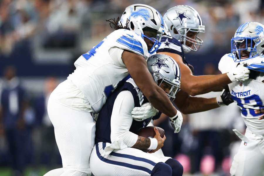 Lions defensive tackle Alim McNeill tackles Cowboys quarterback Dak Prescott