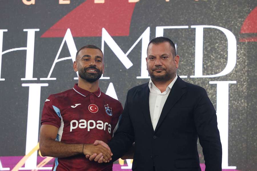 Trabzonspor president Ertugrul Dogan shakes hands with new signing Mohamed Salah