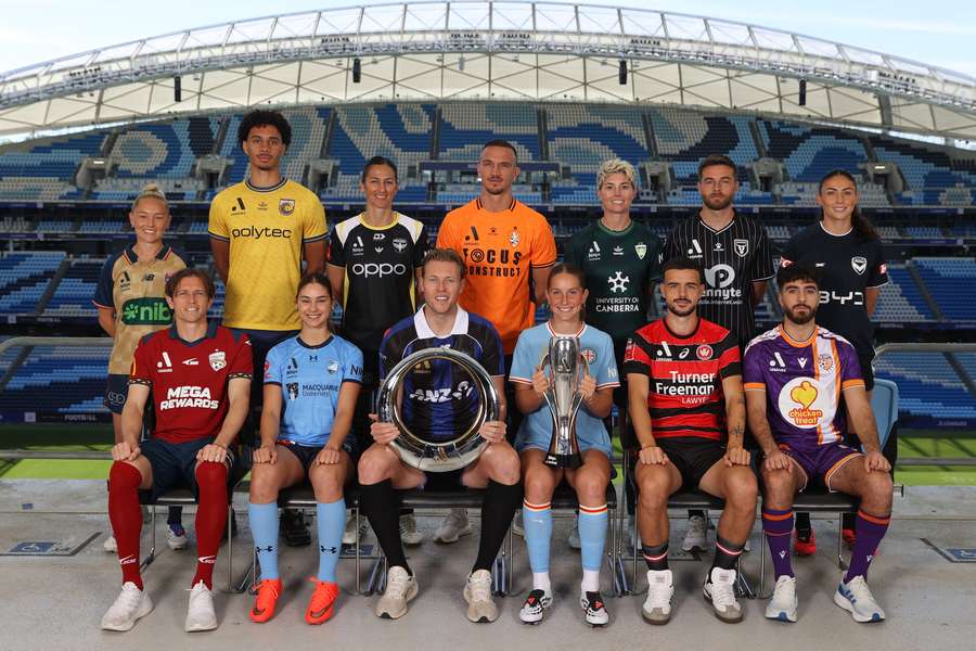A-League Men and Women players pose with the two Championship trophies at a season launch in Sydney. A-League Men and Women players pose with the two Championship trophies at a season launch in Sydney.