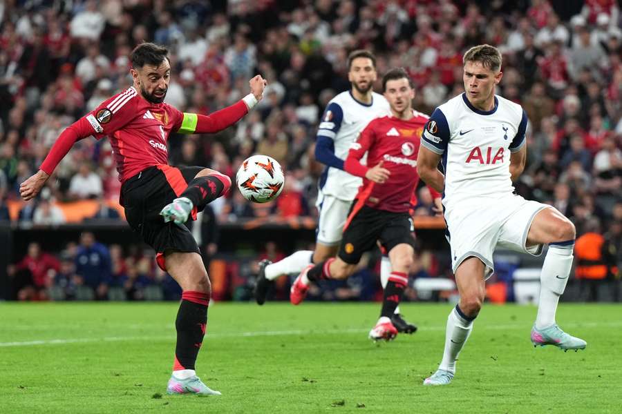 Tottenham Hotspur's Micky van de Ven challenges Manchester United's Bruno Fernandes Tottenham Hotspur's Micky van de Ven challenges Manchester United's Bruno Fernandes