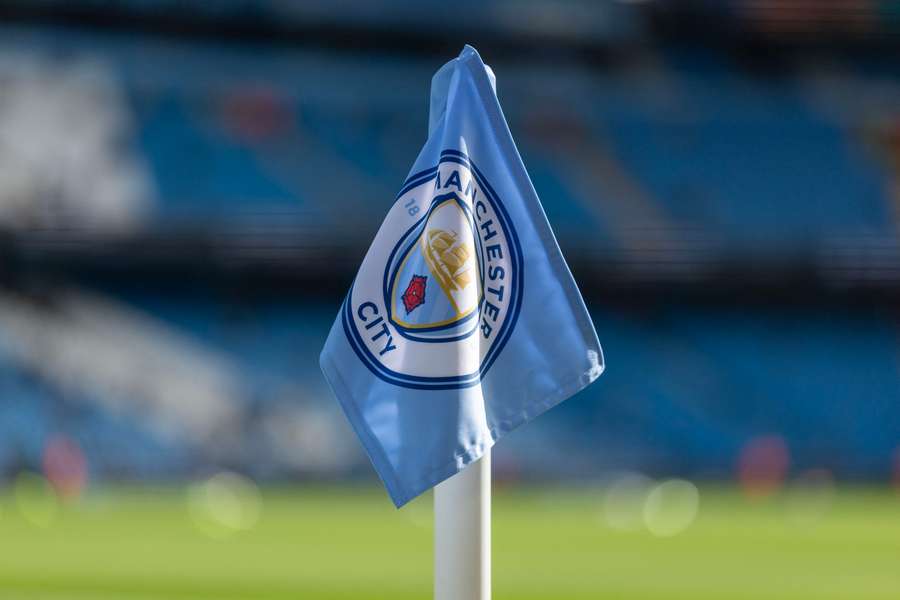 A corner flag is visible at the City of Manchester Stadium