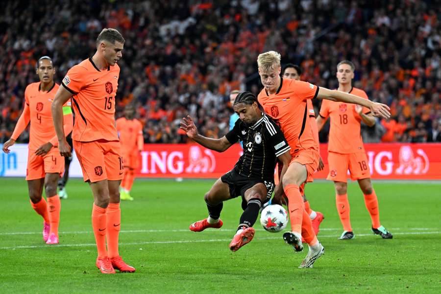 Jan Paul van Hecke battles Germany's Kevin Schade as Micky van de Ven watches