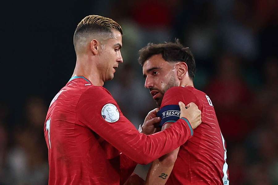 Cristiano Ronaldo hands the captain's armband to Bruno Fernandes