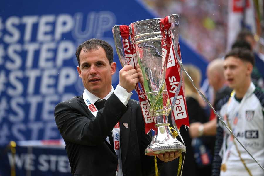 Regis Le Bris, manager of Sunderland, lifts the Sky Bet Championship Play-Off trophy 