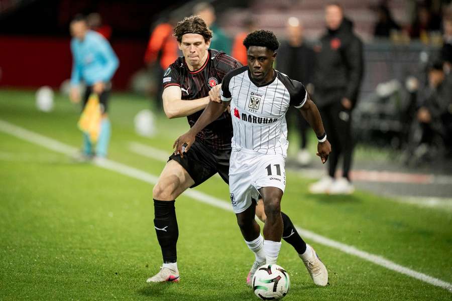 FC Midtjylland's Mads Bech Soerensen and Sint Truidense's Nathanaël Mbuku in action FC Midtjylland's Mads Bech Soerensen and Sint Truidense's Nathanaël Mbuku in action
