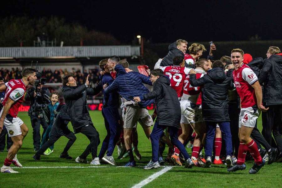 Fleetwood Town celebrate winning the penalty shootout against Arsenal with their fans