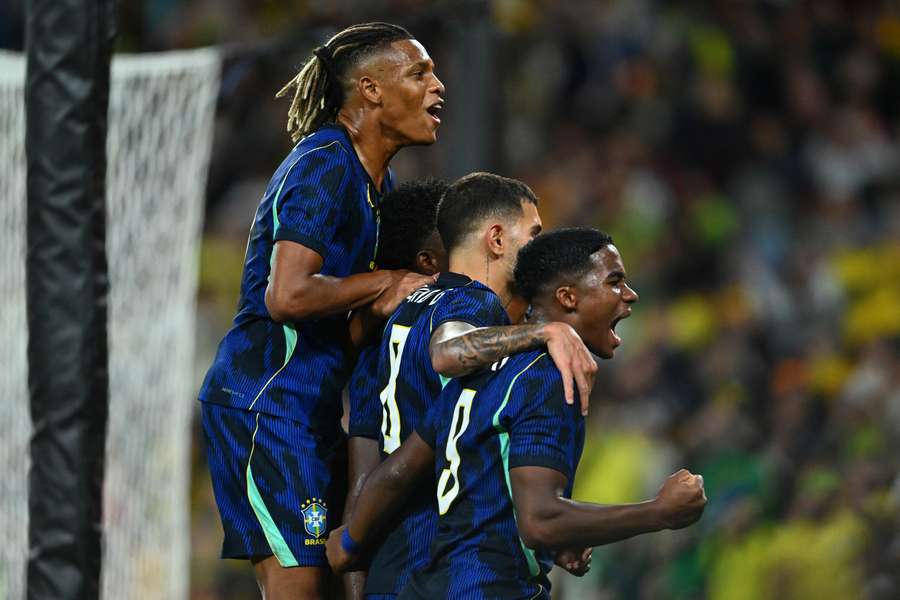 Vinicius Junior and teammates celebrate his penalty goal against Australia in Brisbane.