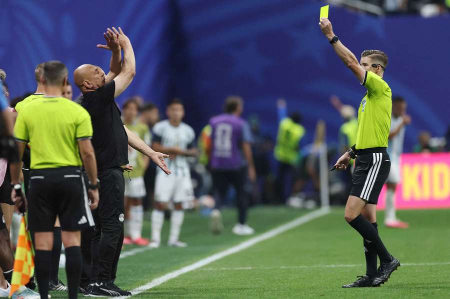 Egypt coach Hossam Hassan is shown a yellow card by referee Francois Letexier during the match with Argentina Egypt coach Hossam Hassan is shown a yellow card by referee Francois Letexier during the match with Argentina