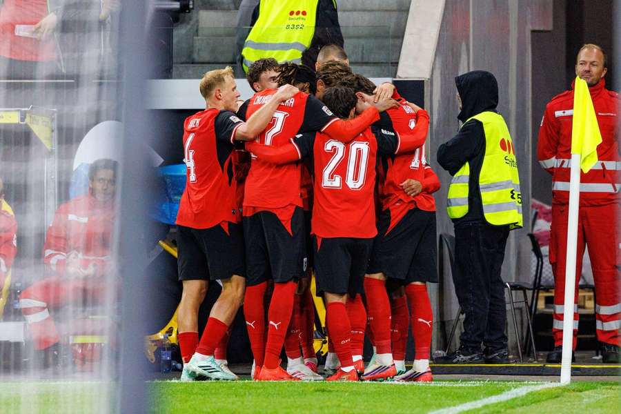 Austria celebrate their third goal