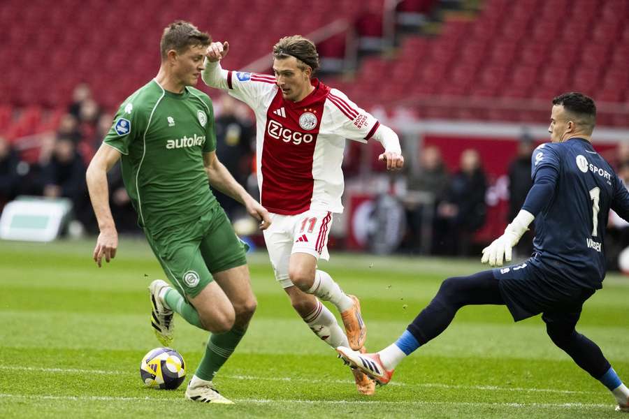 Ajax's Mika Godts dribbles his way past Groningen goalkeeper Etienne Vaessen Ajax's Mika Godts dribbles his way past Groningen goalkeeper Etienne Vaessen