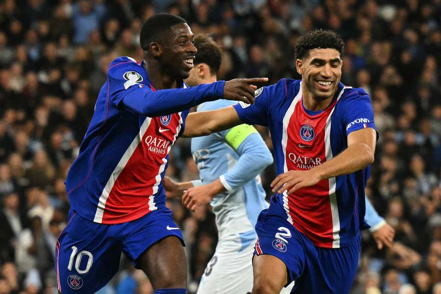 Dembele (left) celebrates scoring for PSG
