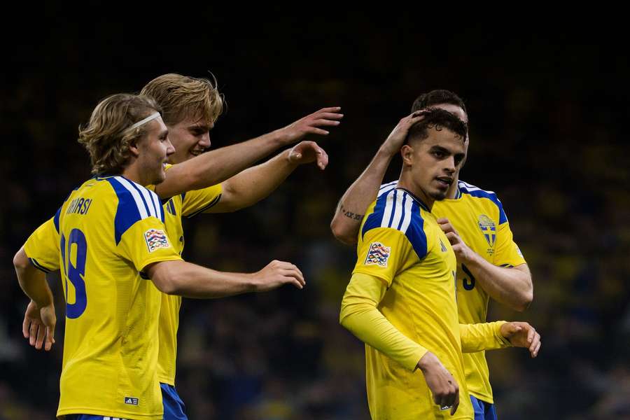 Teammates surround Yasin Ayari after he put Sweden 2-1 up