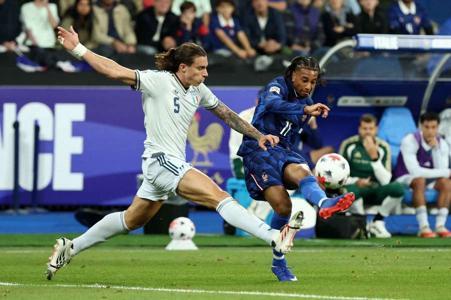 Italy's Riccardo Calafiori in action with France's Michael Olise Italy's Riccardo Calafiori in action with France's Michael Olise