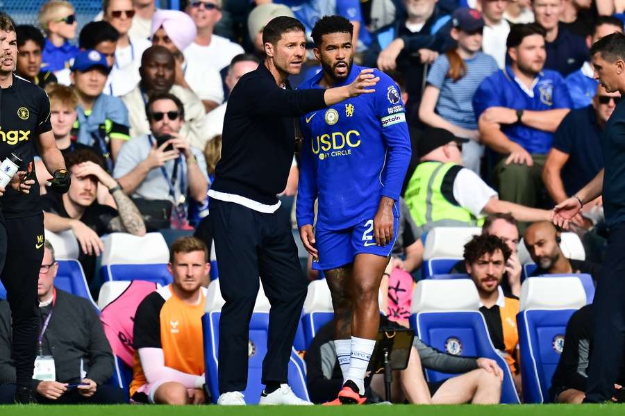 Xabi Alonso talking to defender Reece James. Xabi Alonso talking to defender Reece James.